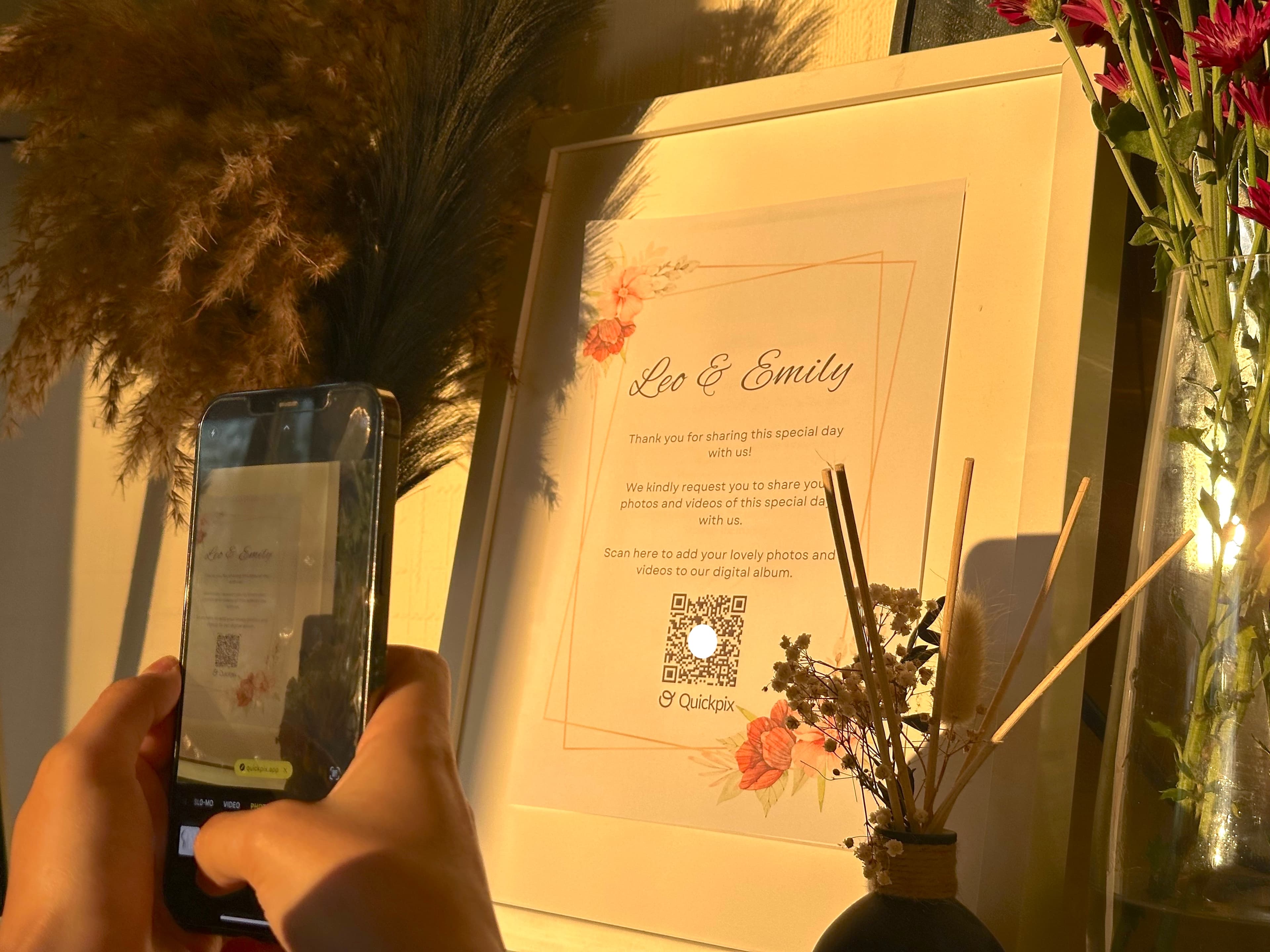 A QR code displayed on a wedding table card for guests to scan and upload photos.