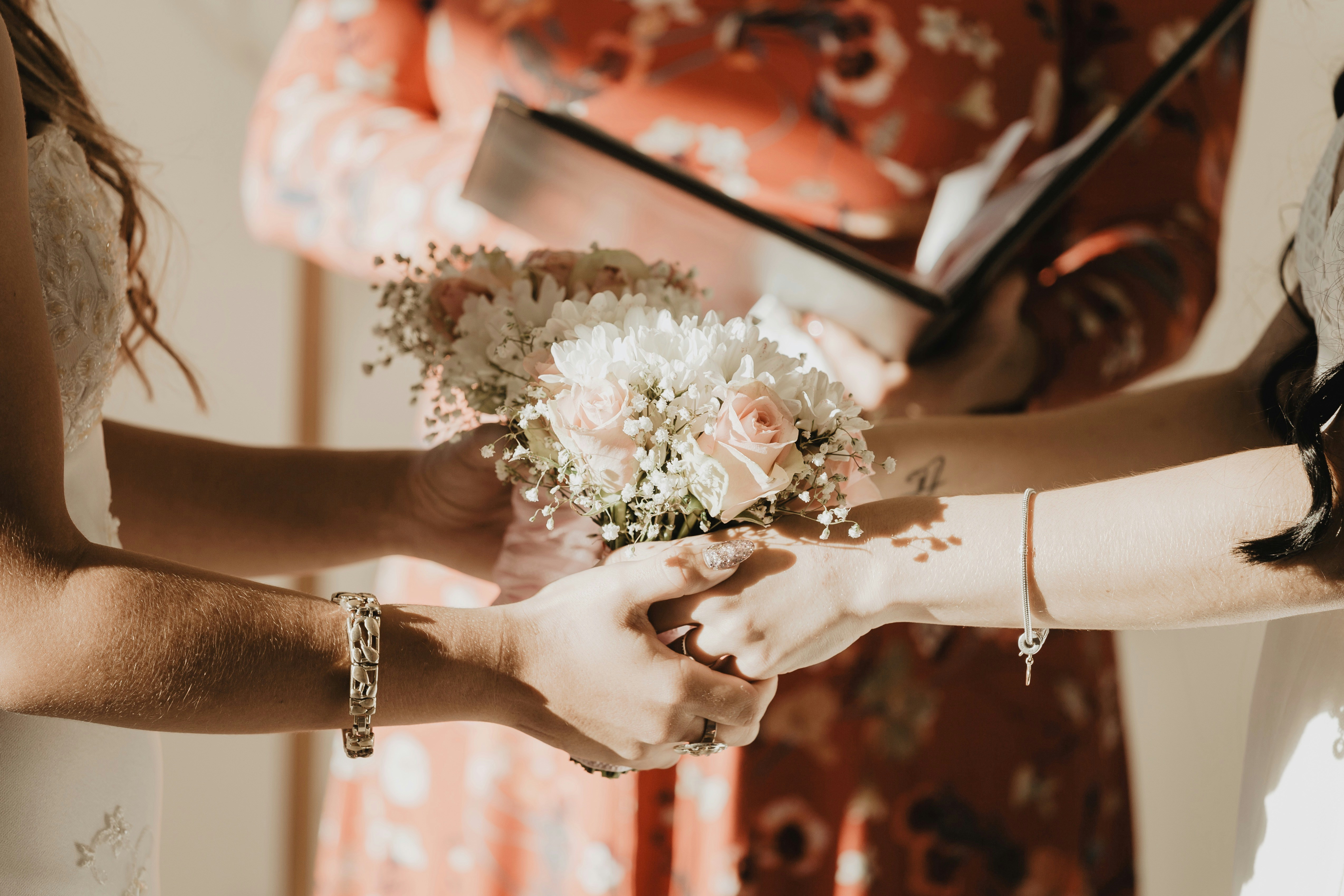 Person holding a white flower bouquet