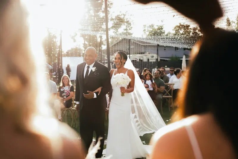 Bride and groom standing on a street during daytime