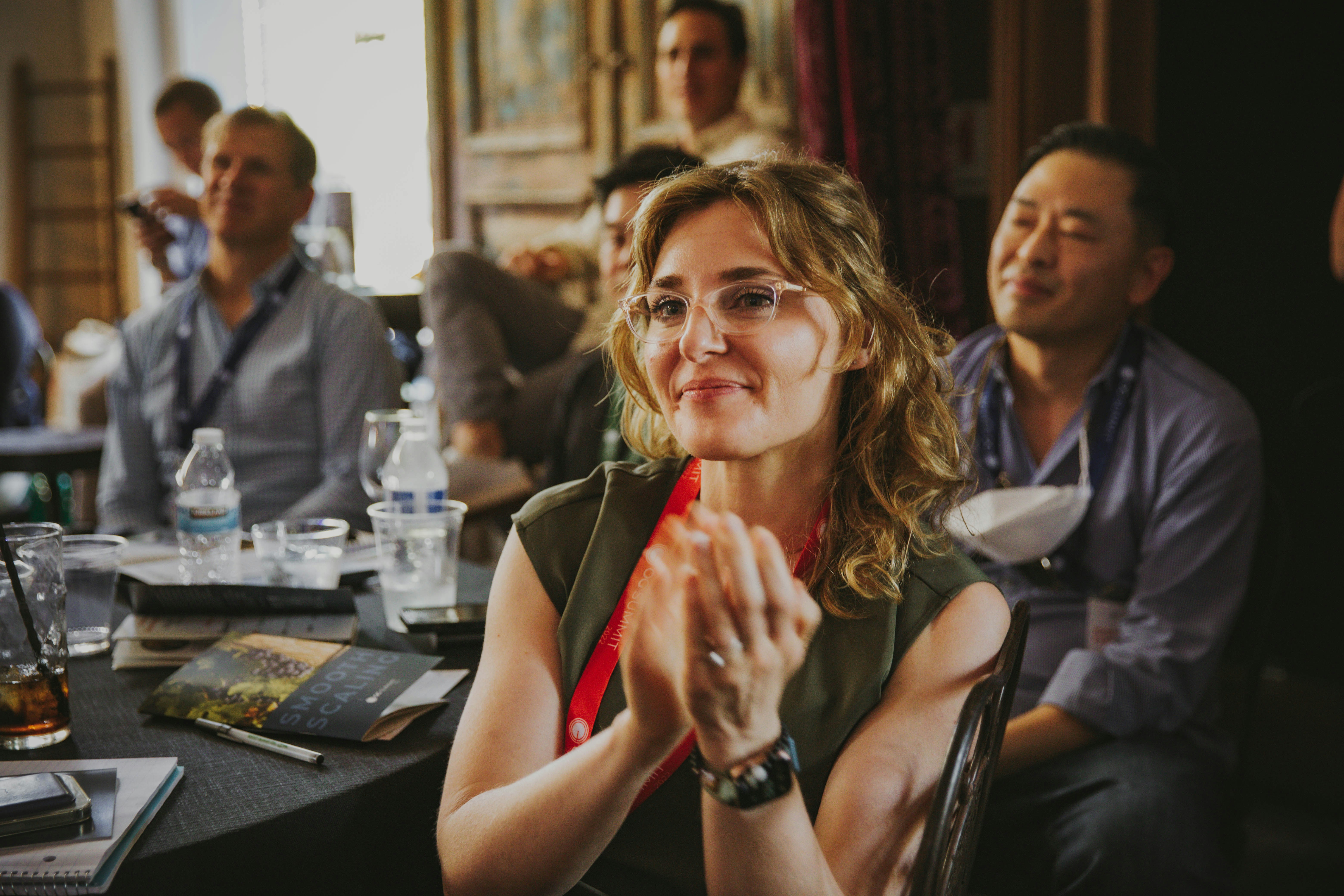 A group of people sitting around a table at a corporate event