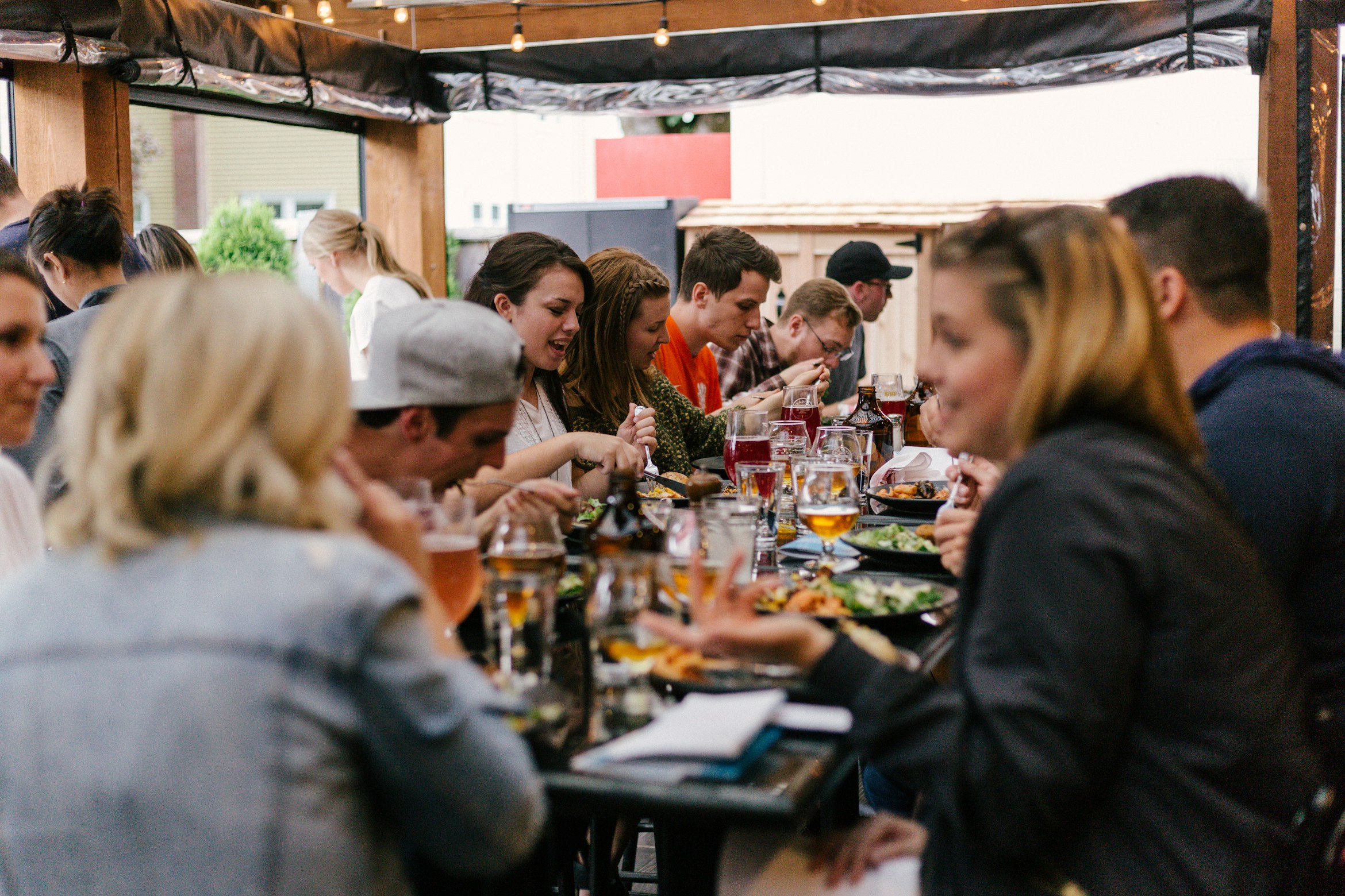 People sitting in front of a table talking and eating